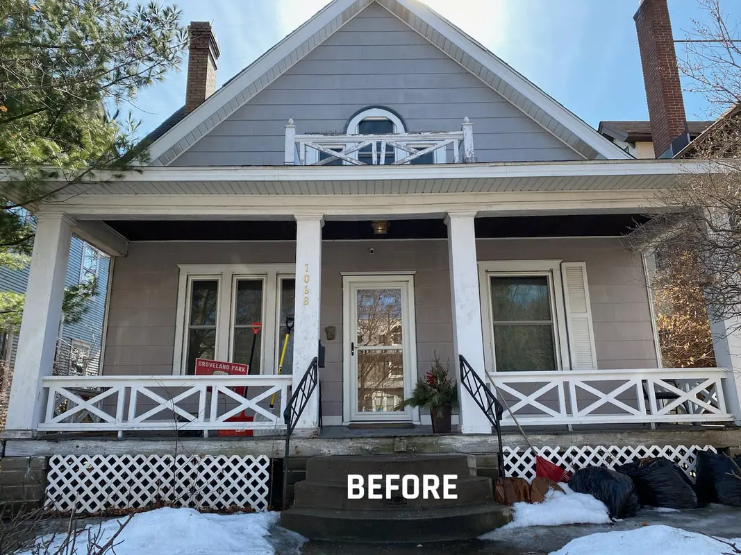 Gray house exterior before renovation with snow.