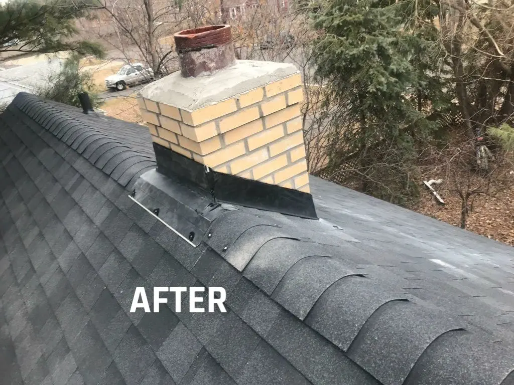 Chimney on shingled roof after repair.