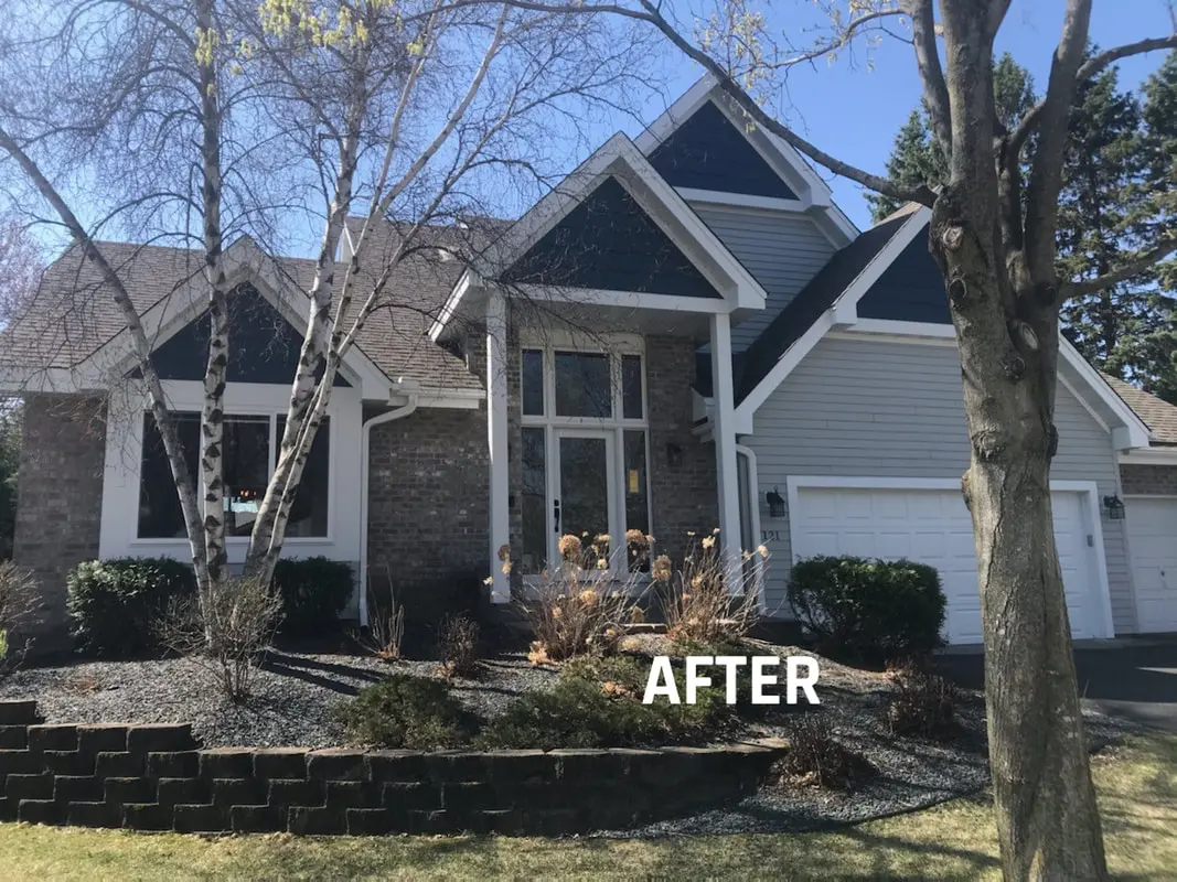 Renovated house exterior with landscaped yard.