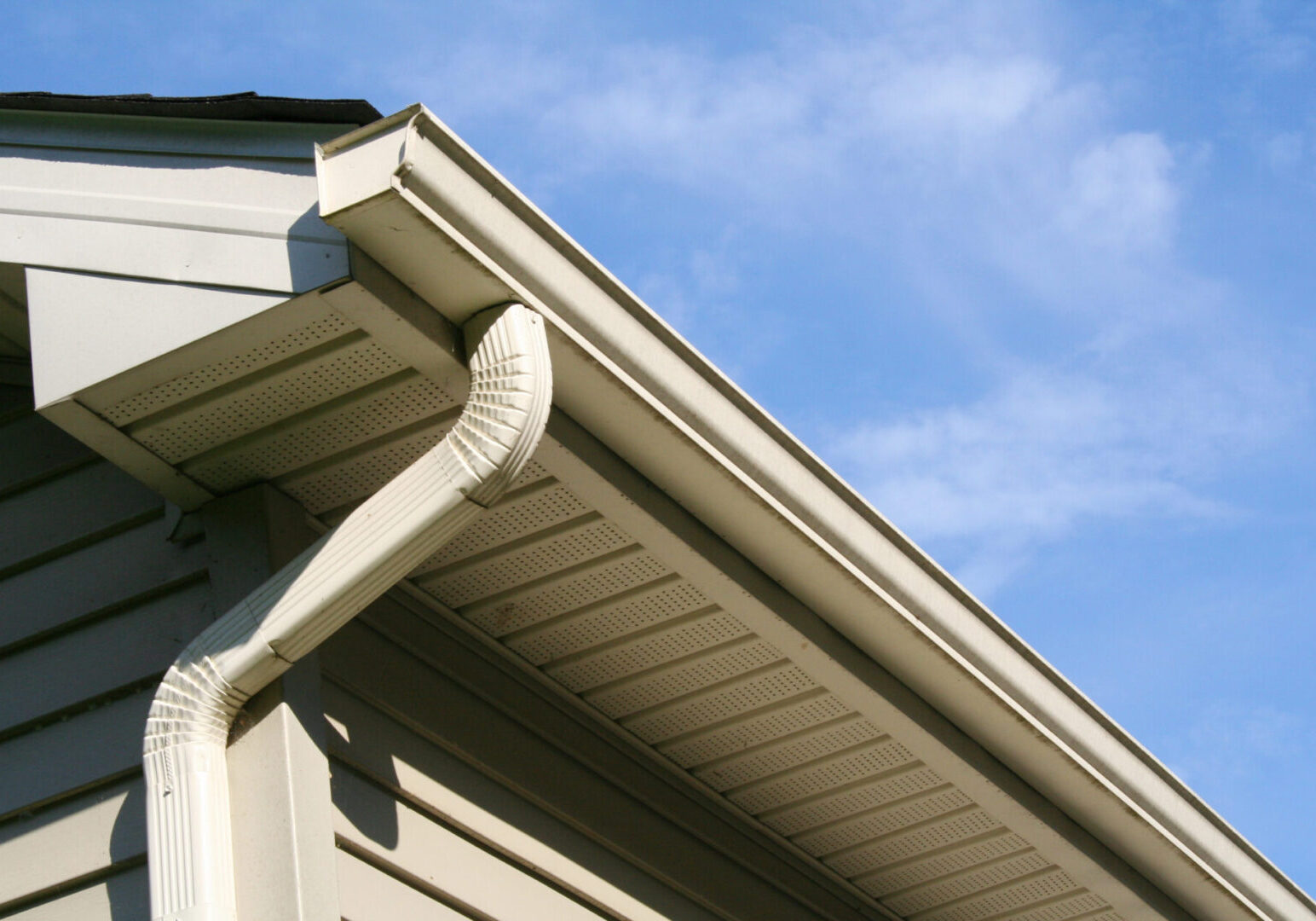 House with Gutter and Downspout Angled view of gutter and downspout on a house