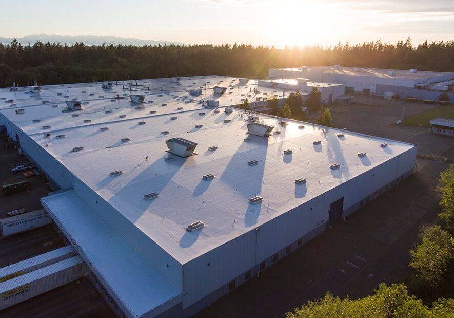 travis-industries-4_orig Large warehouse buildings at sunset aerial view.